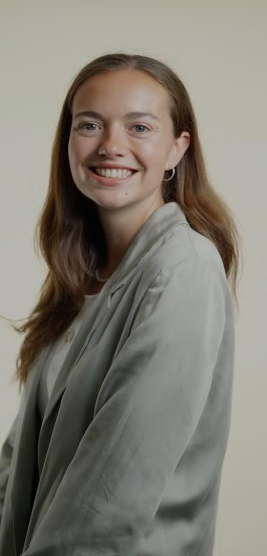 Professional portrait of a Niya executive assistant wearing a grey blazer